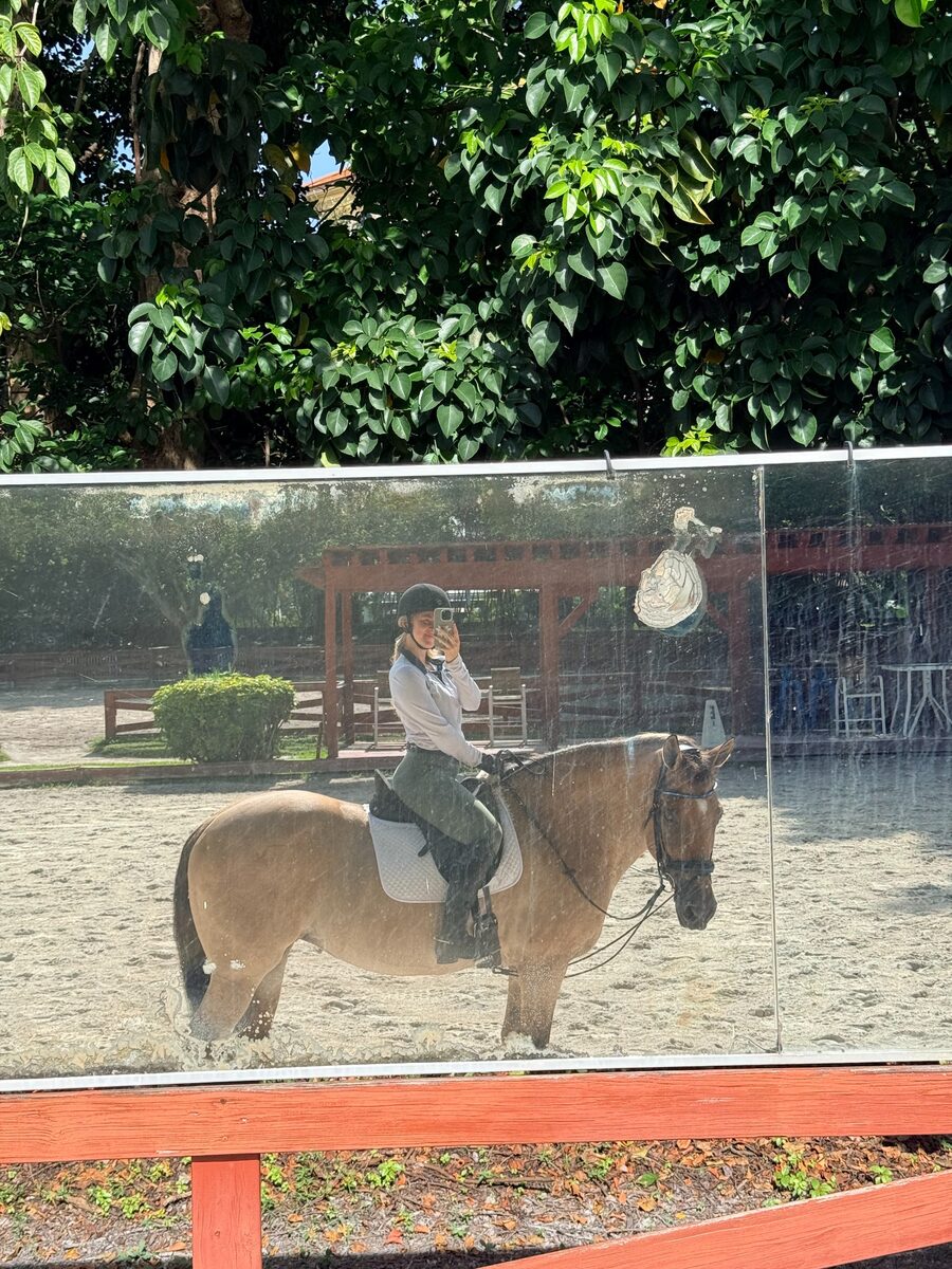 Shelby taking a mirror photo while horseback riding